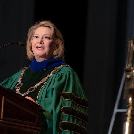 President Lori Gonzalez speaks at a podium